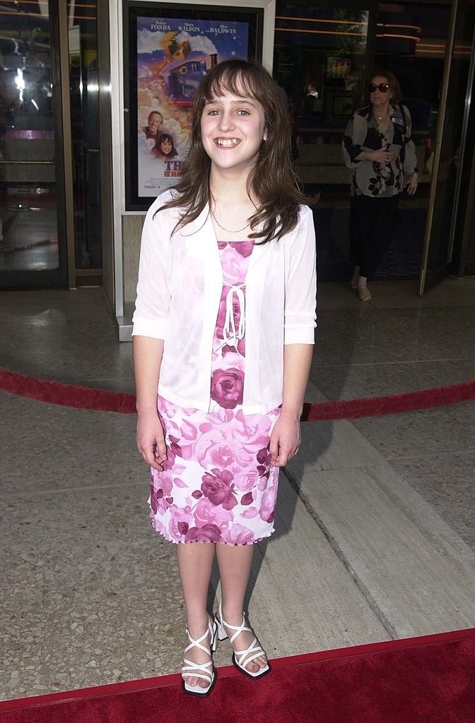 young Mara outside a theater