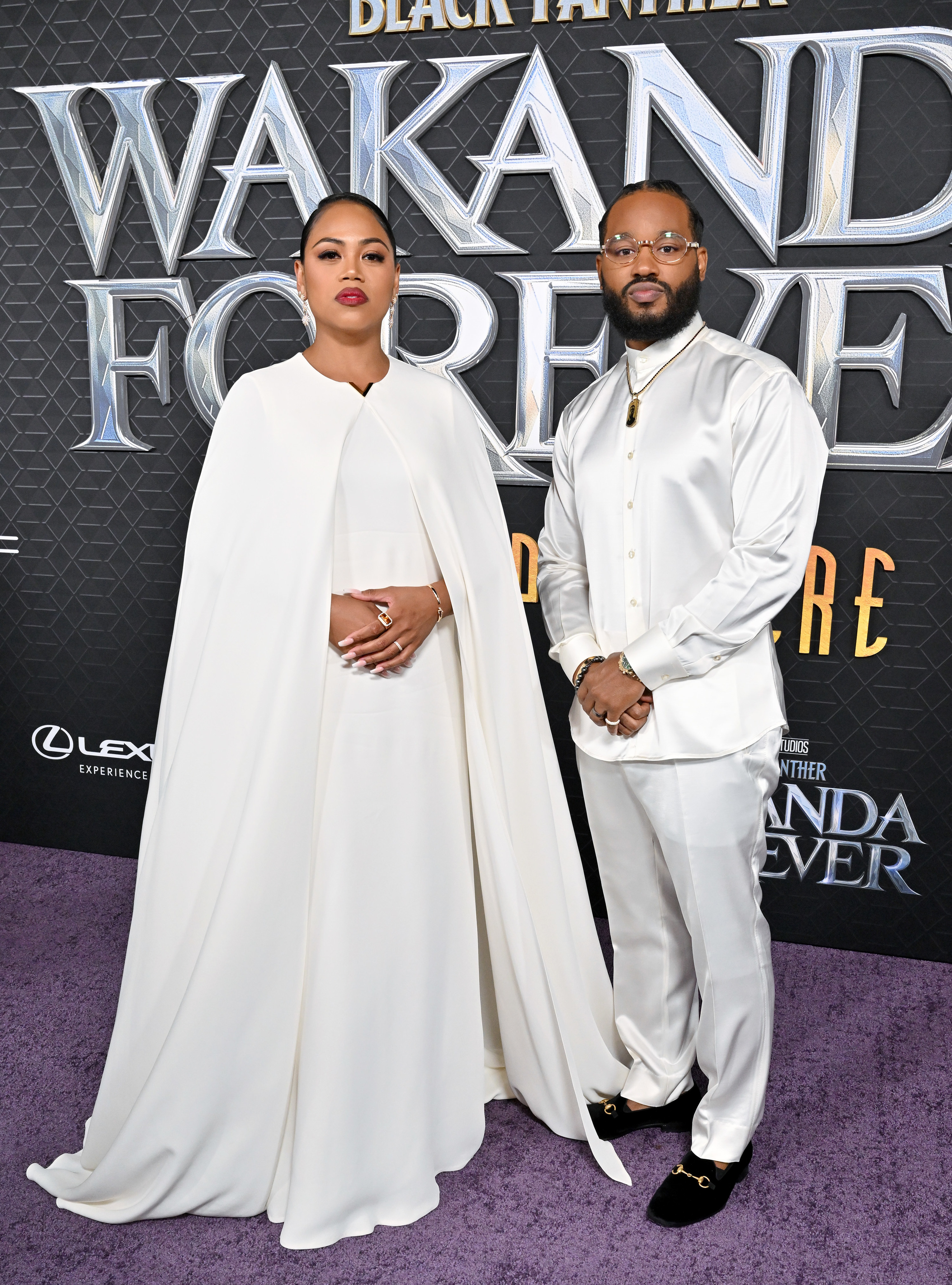 Ryan wore a white silk top and pants with a chain in honor of Chadwick Boseman, and Zinzi wore a white dress with a flowing cape