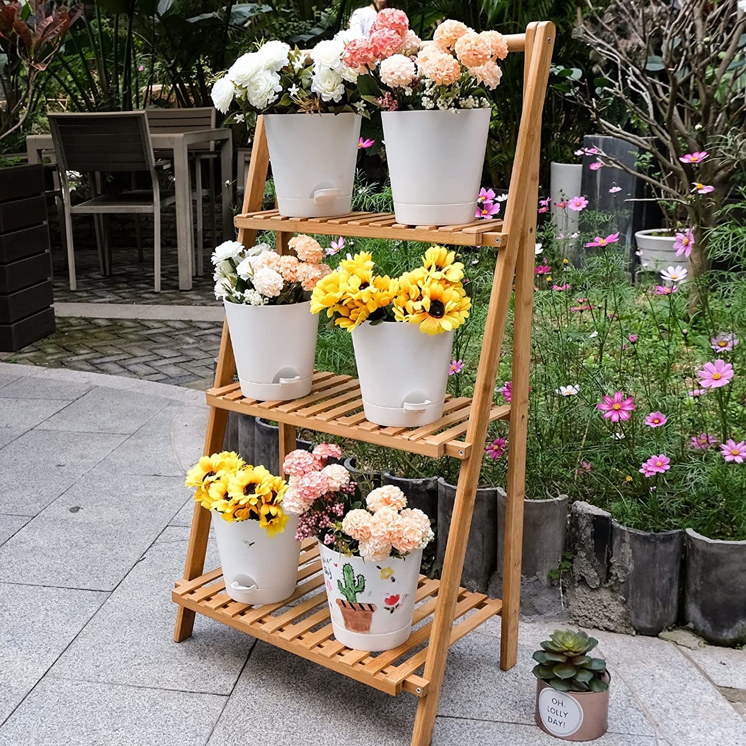 the six pots filled with flowers on a plant stand outside
