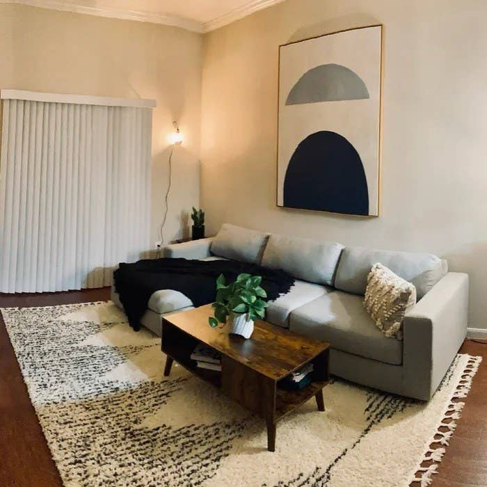 the rug in a living room with a grey couch and coffee table