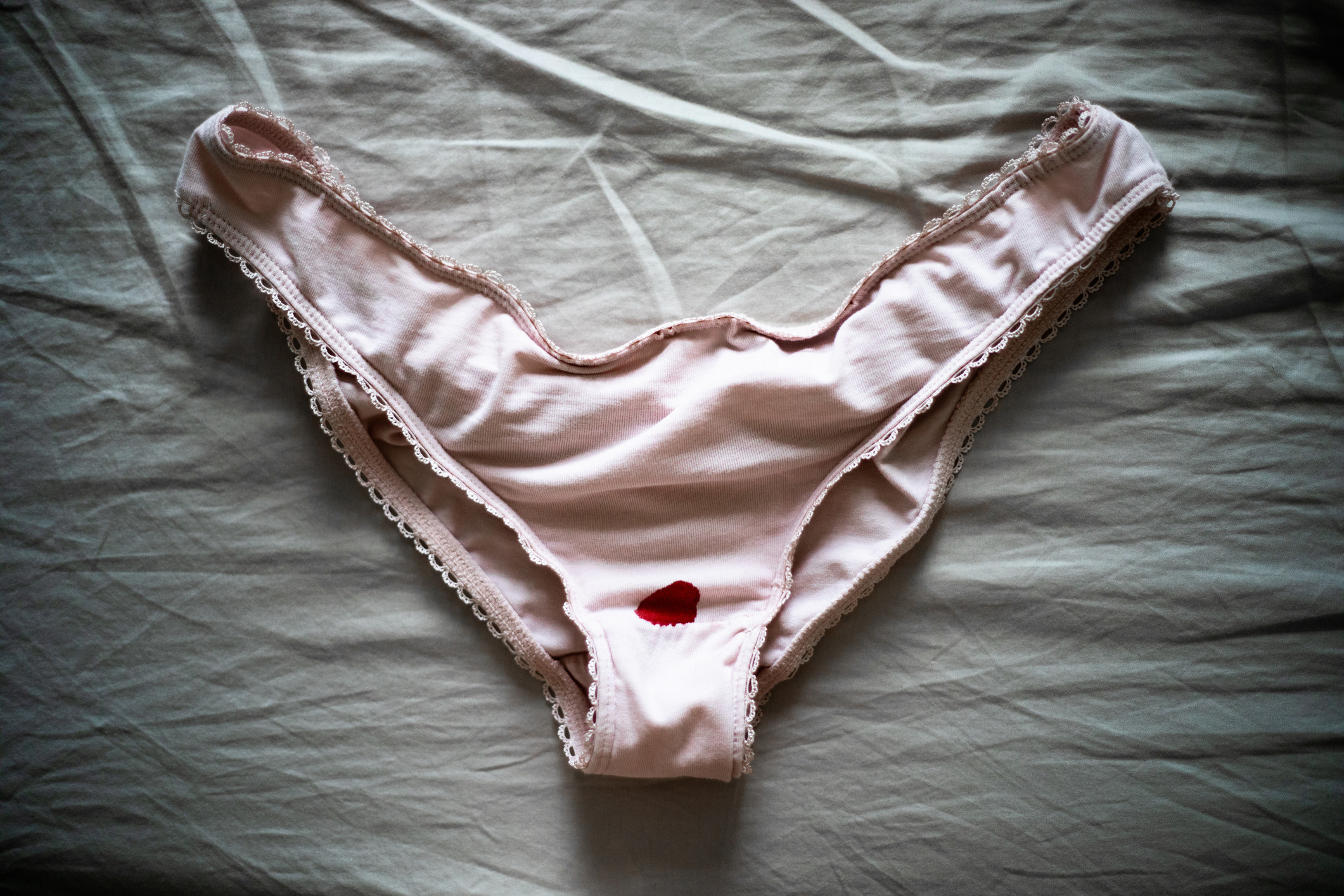 A pair of panties with a bloodstain at the crotch