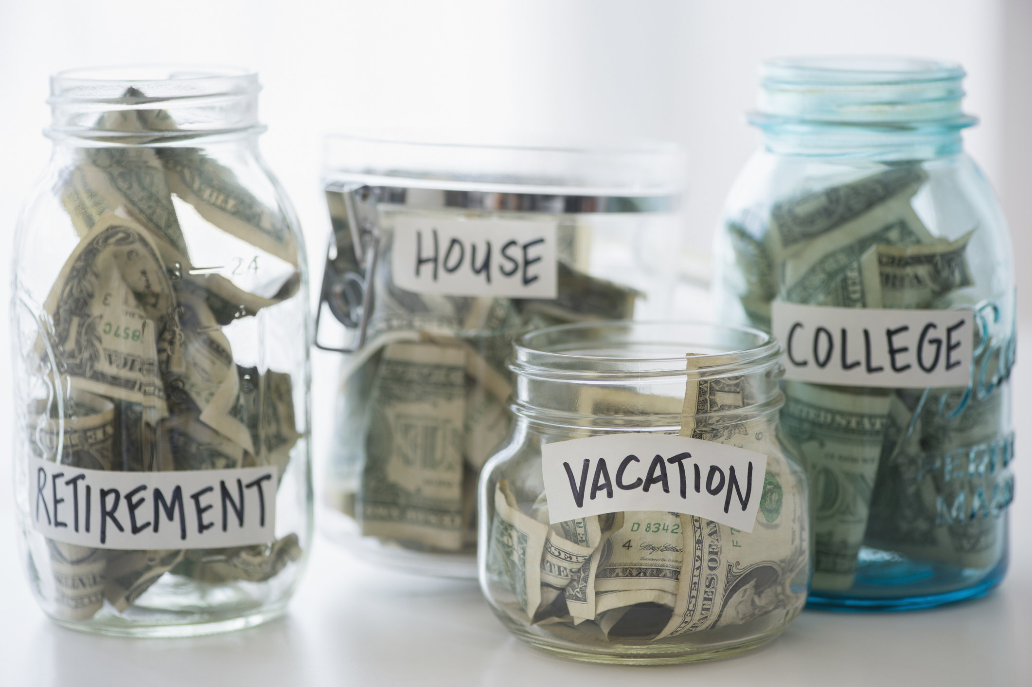different jars for vacation, house, college, and retirement money