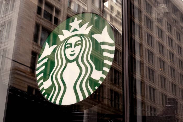 A Starbucks logo hangs in the window of one of the chain&#x27;s coffee shops in the Loop on January 04, 2022 in Chicago, Illinois