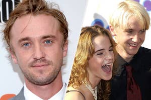 Tom Felton wears a gray suit with a white shirt. Emma Watson wears a black tank top with a white necklace of a cross and a matching bangle bracelet while Tom Felton wears a black shirt with a red tie.