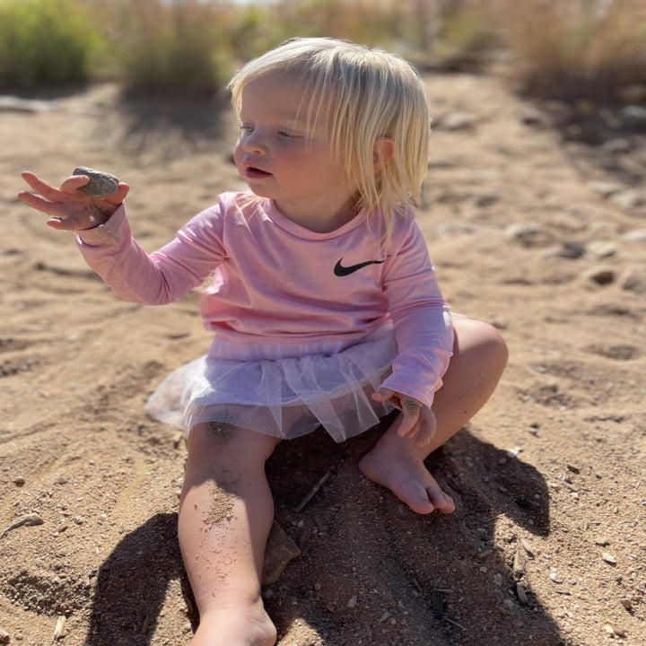 author's daughter playing in the sand box