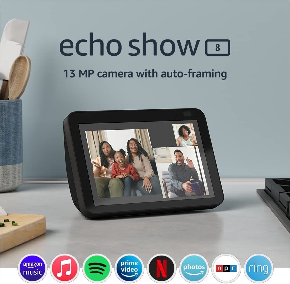 the echo show 8 with three photos displayed on its screen, along with icons of compatible apps at the bottom