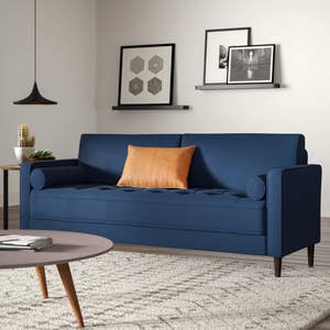 a dark blue sofa in a living room