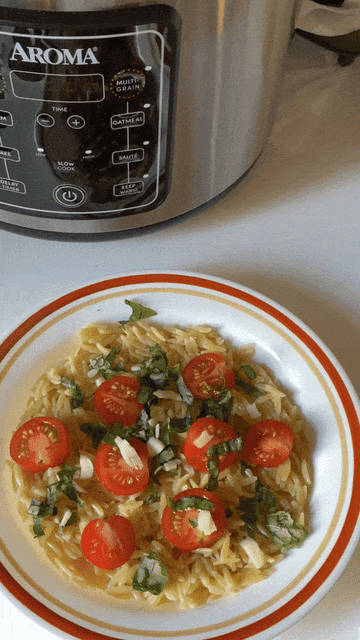 gif of green onion slices being sprinkled onto cooked orzo dish