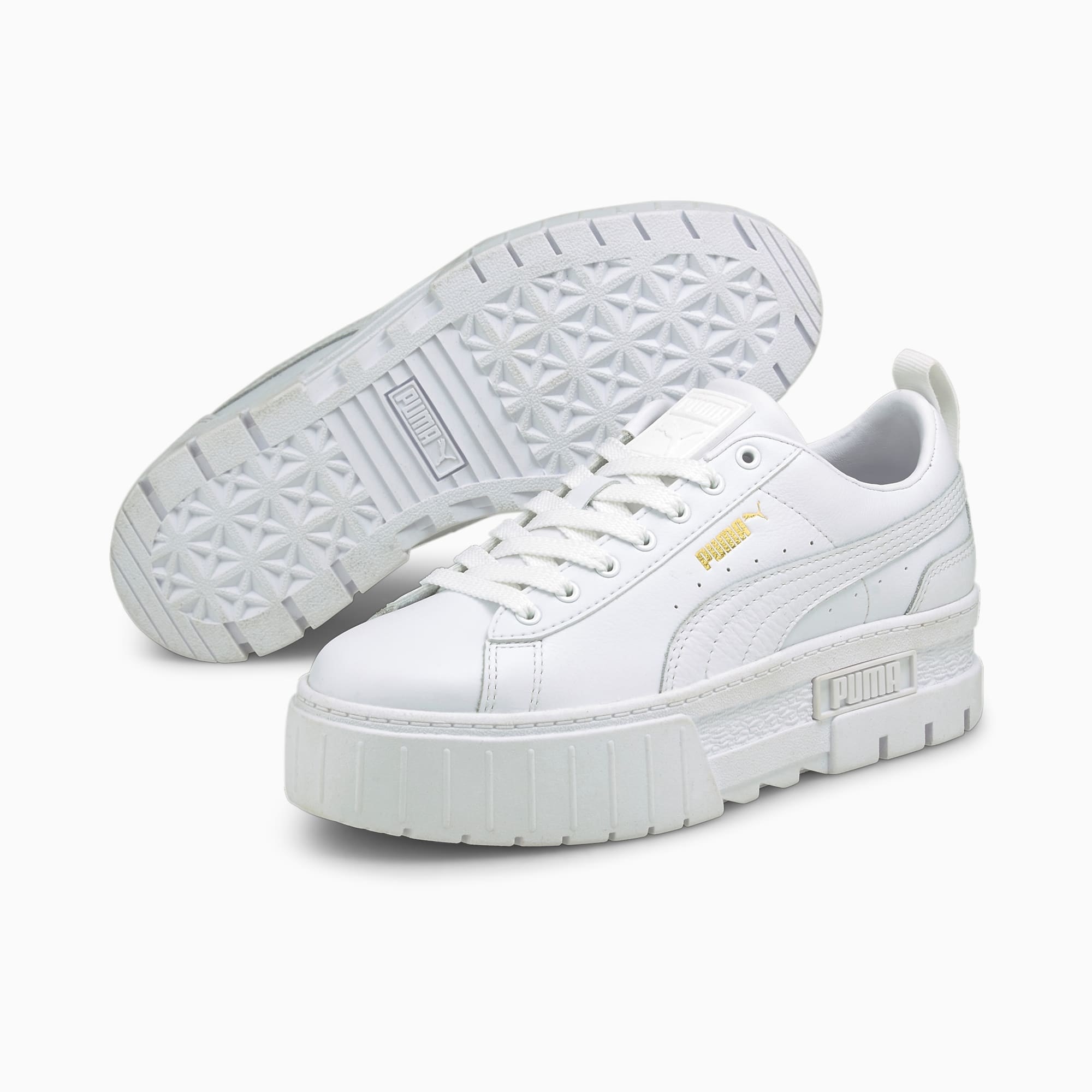 a pair of white Puma platform sneakers