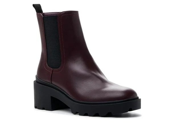 A pair of red chelsea boots with black lug sole