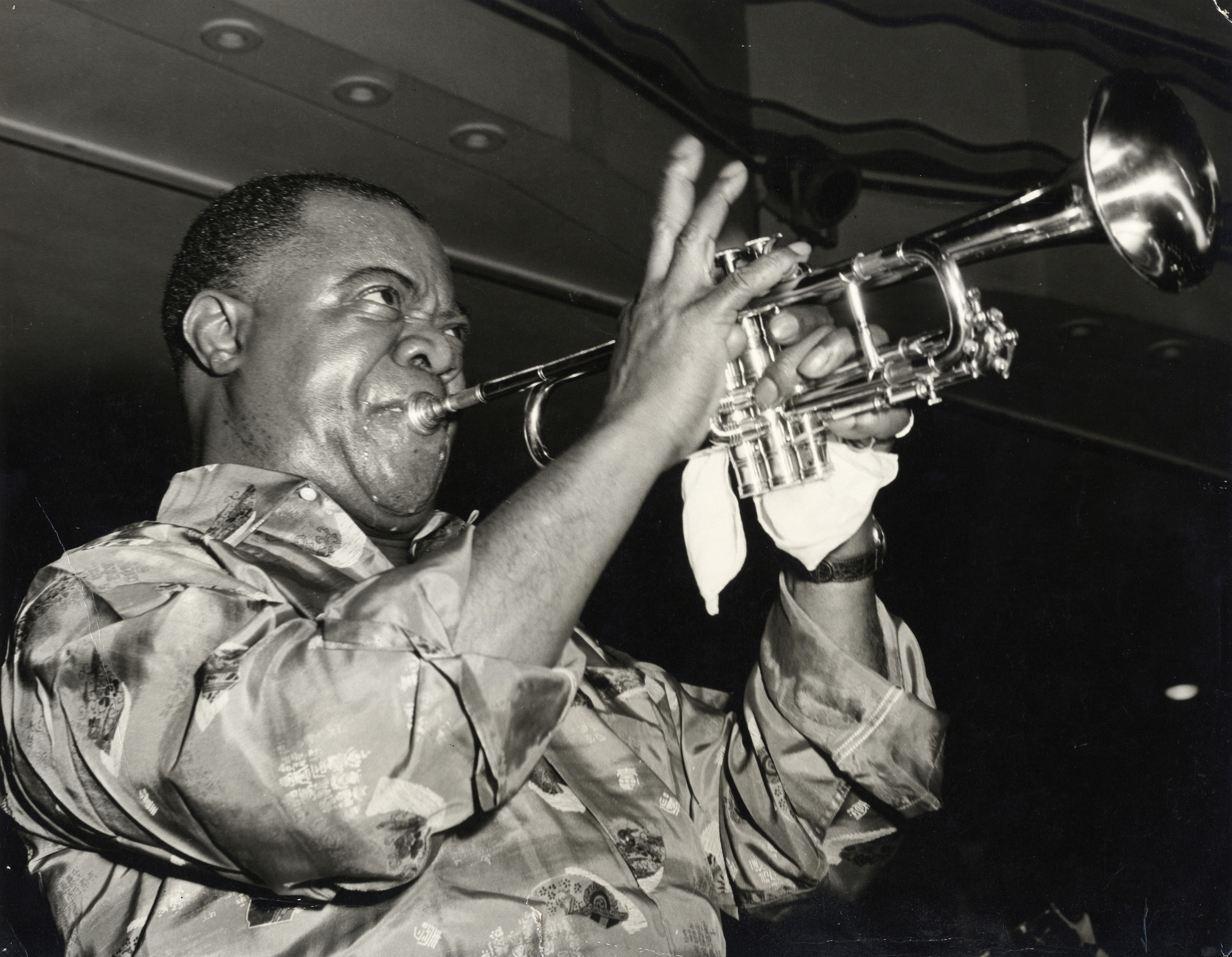 Louis Armstrong plays the trumpet