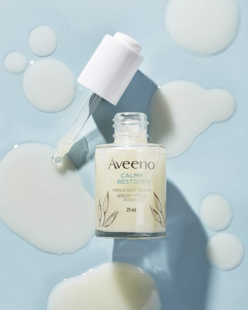 a bottle of the aveeno calming serum on a simple background