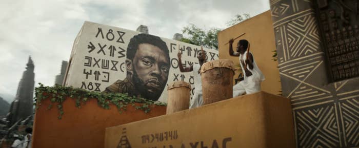 A mural of Chadwick next to two drummers