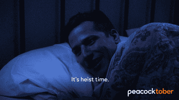 Jake from &quot;Brooklyn Nine-Nine&quot; smiles as he cuddles up in bed and says, &quot;It&#x27;s heist time&quot;