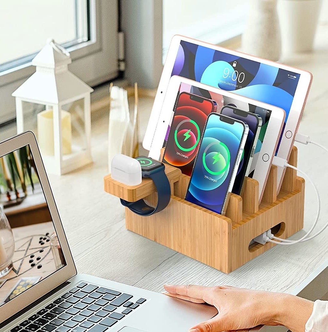 the charging dock on a desk with devices charging in it
