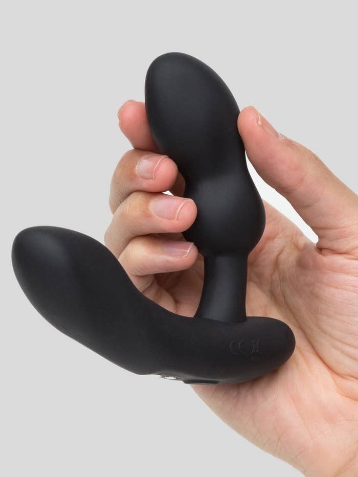 A hand holding the massager