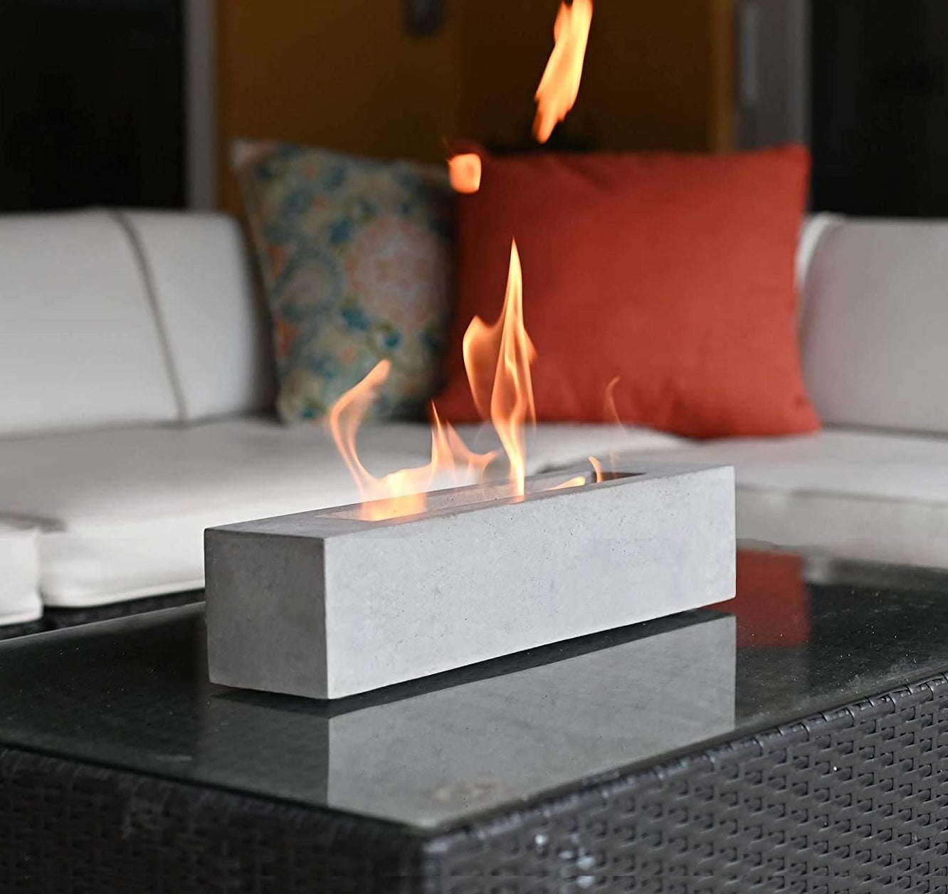 the tabletop fire pit on top of an outdoor table with fire coming out