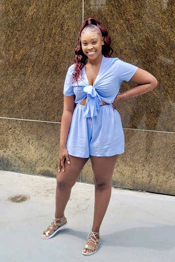 reviewer wearing the blue short-sleeve romper
