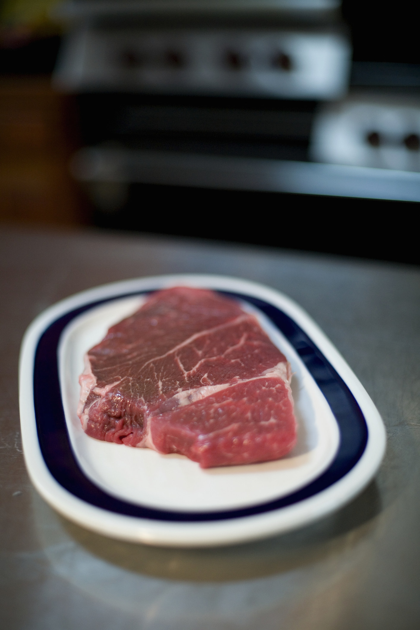 Steaks on a plate in the kitchen.
