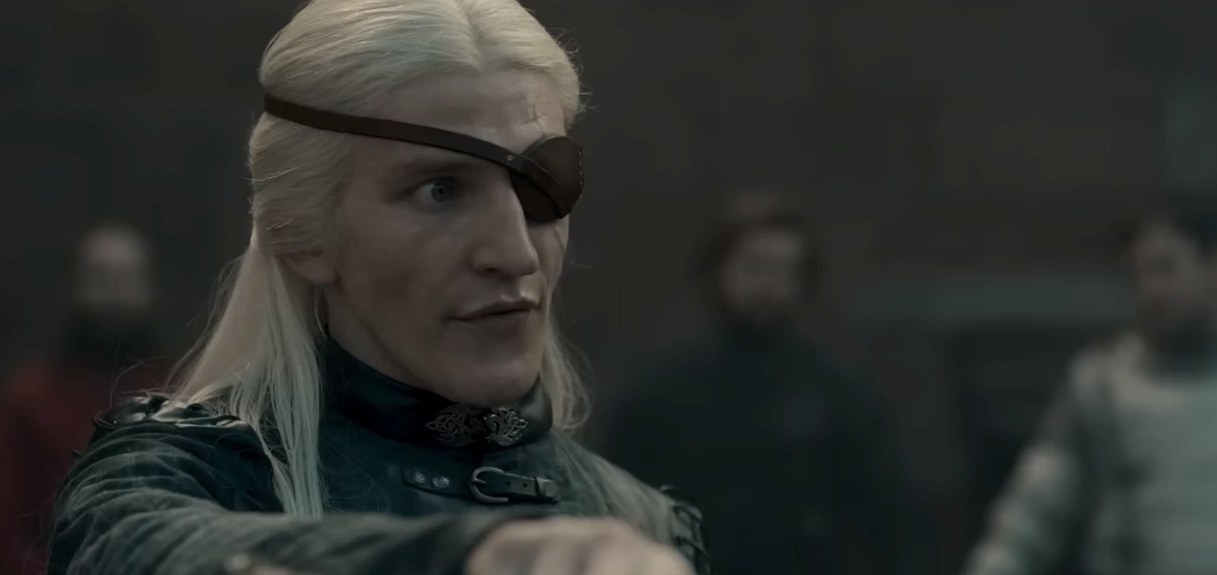 Aemond wears an eye patch and looks serious
