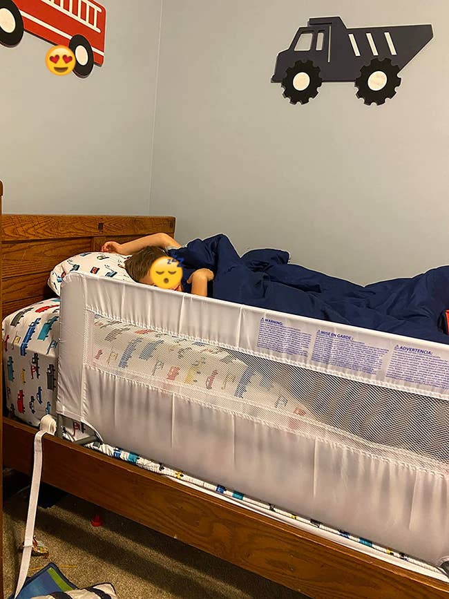 Reviewer's photo of the rail installed on their child's bed
