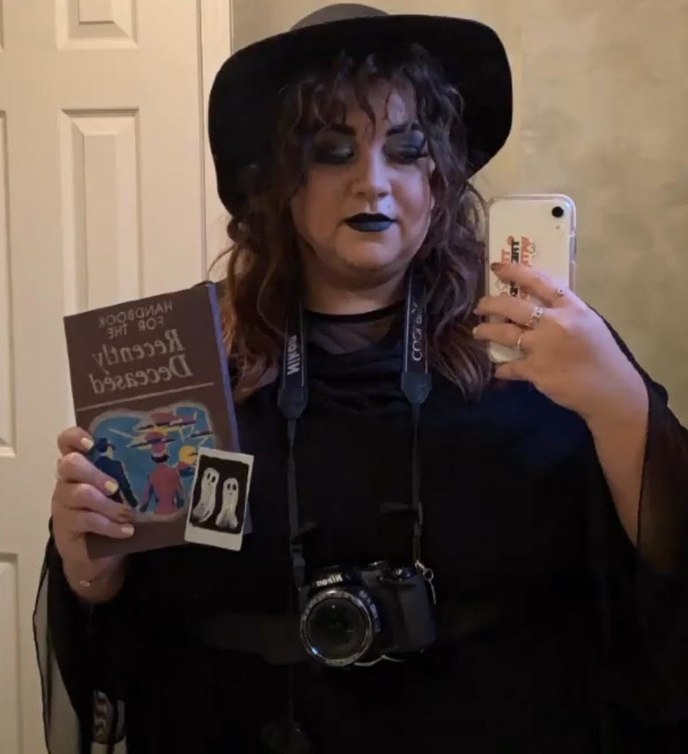 Bianca holding the notebook while wearing a costume