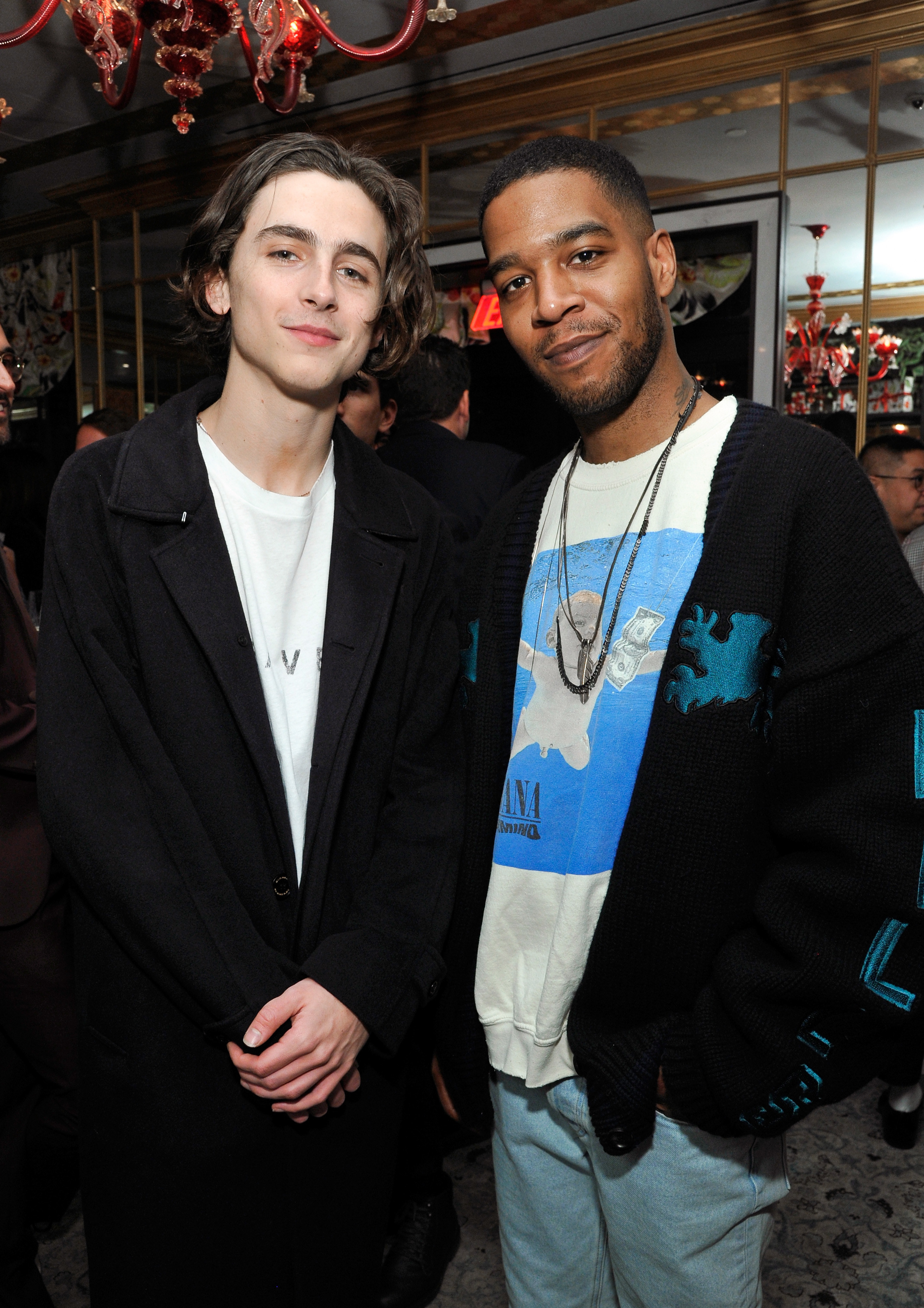 Timothée Chalamet and Kid Cudi pose at a GQ dinner to celebrate the magazine&#x27;s March cover  in 2018