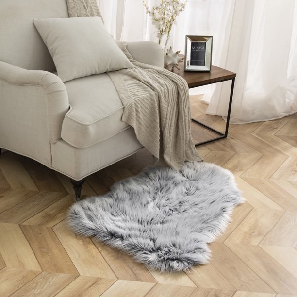 Gray sheepskin rug next to an armchair