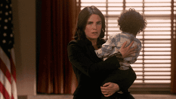 Laurel Castillo carrying her baby and kissing him on &#x27;How To Get Away With Murder&#x27;