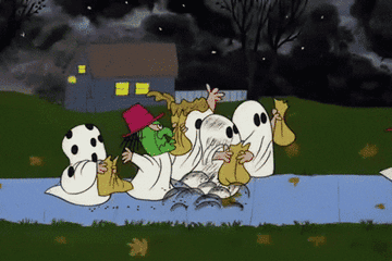 Trick or treaters dressed up as ghosts and witches walking through pumpkin patch from the peanuts