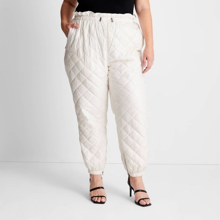model wearing cream quilted joggers