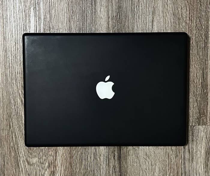 a black macbook with white logo from 2006