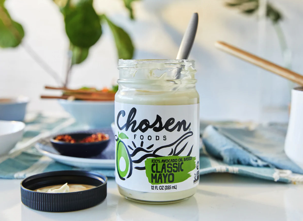 Spoon in jar of Chosen Foods Mayonnaise on table