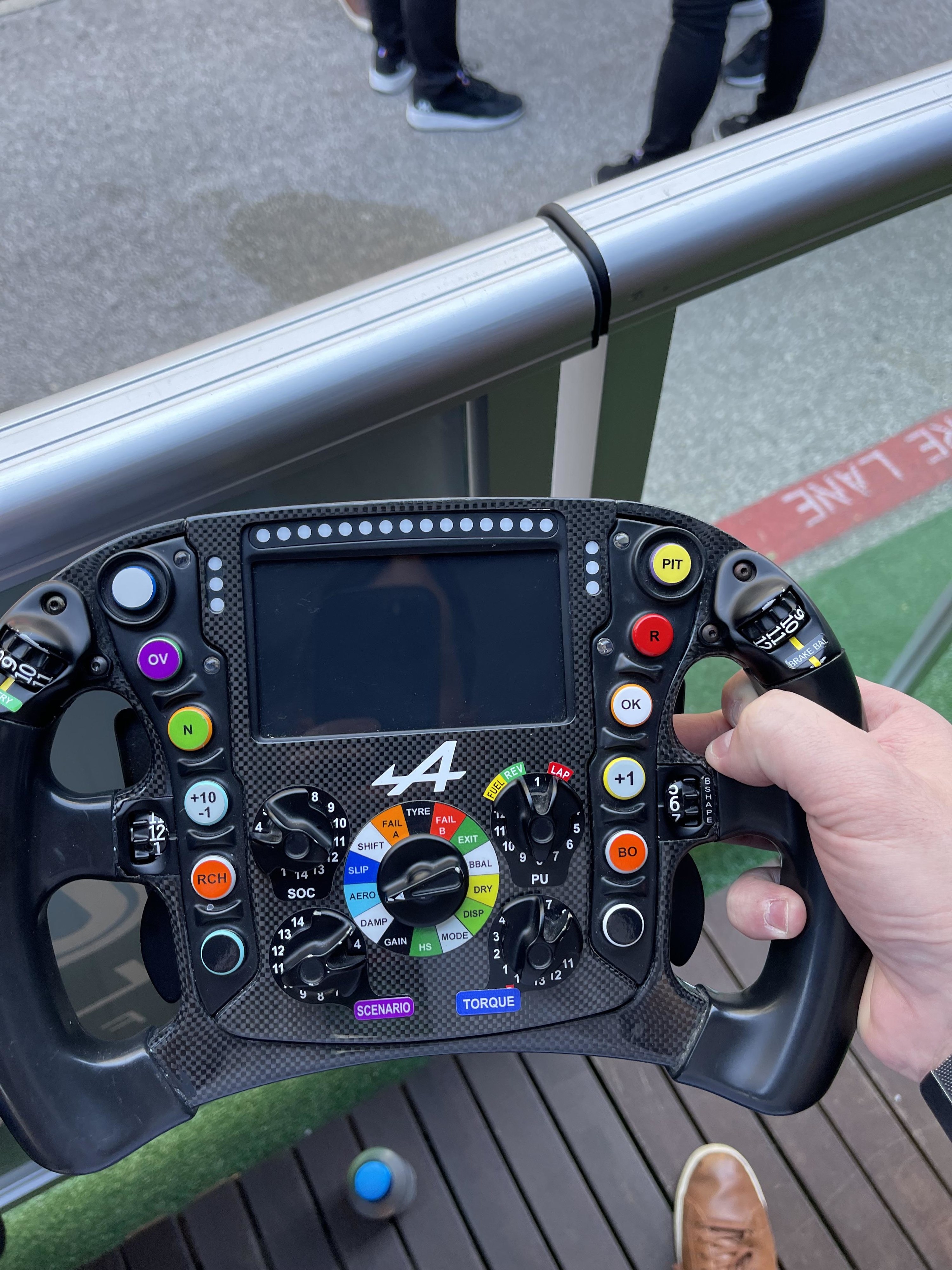 A race car steering wheel that looks like a very intense video game controller