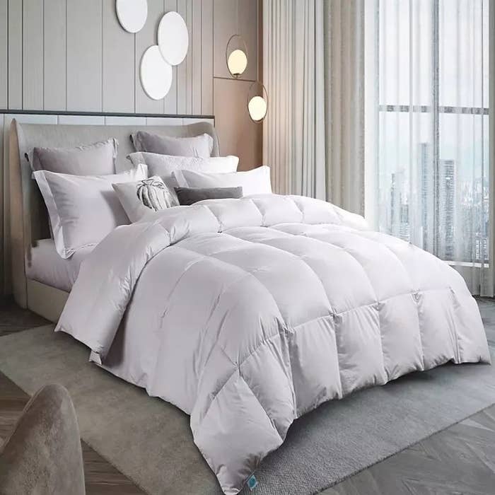 A white comforter on a white bed