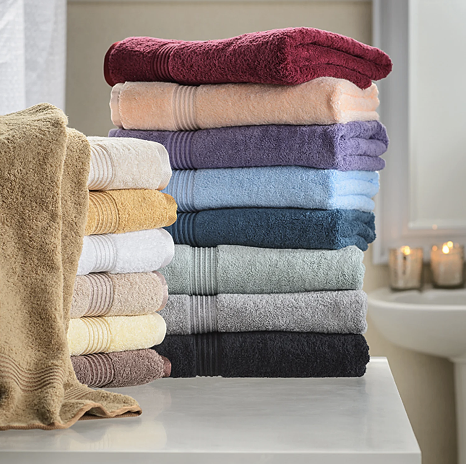 the towels in different colors stacked on a counter