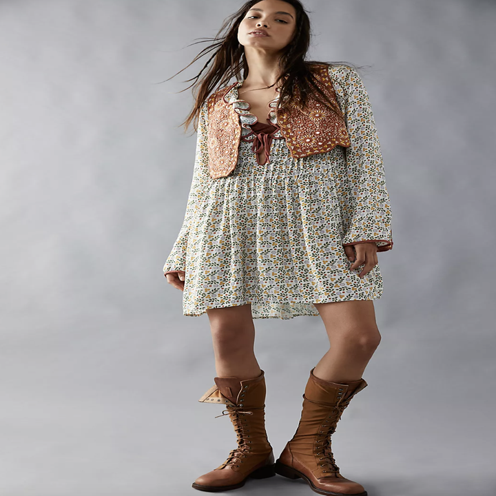 model wearing blossom baby mini dress with brown boots