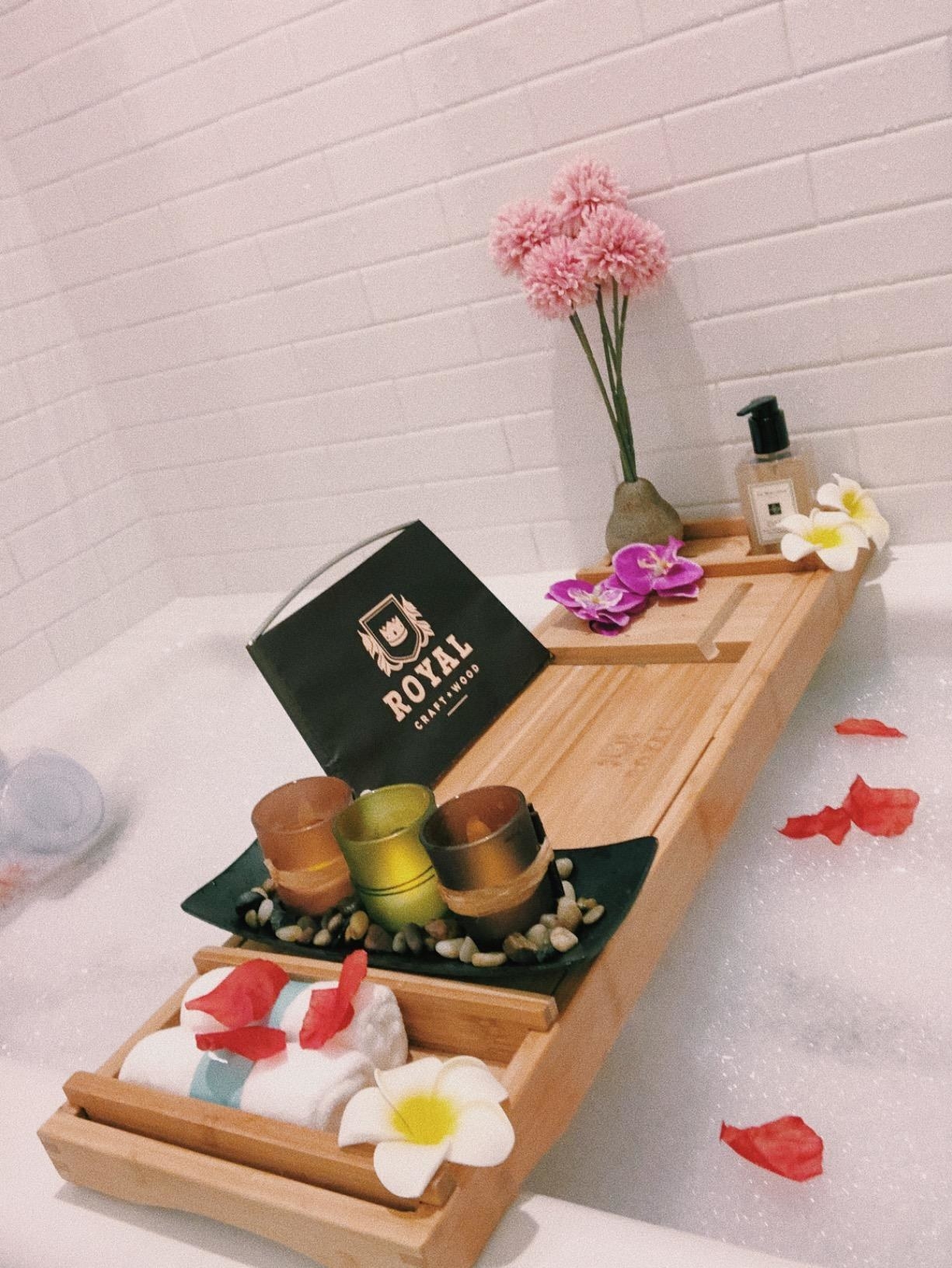 reviewer photo of natural-colored tray with candles and flowers over bubble bath