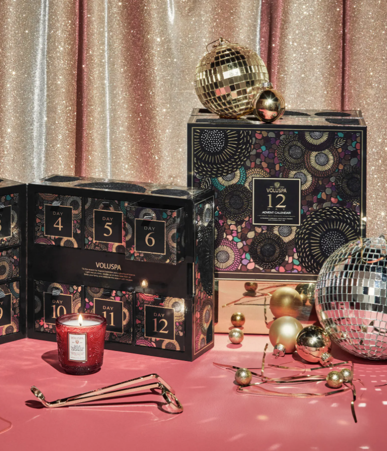 the calendar surrounded by a wick trimmer, ornaments and a disco ball