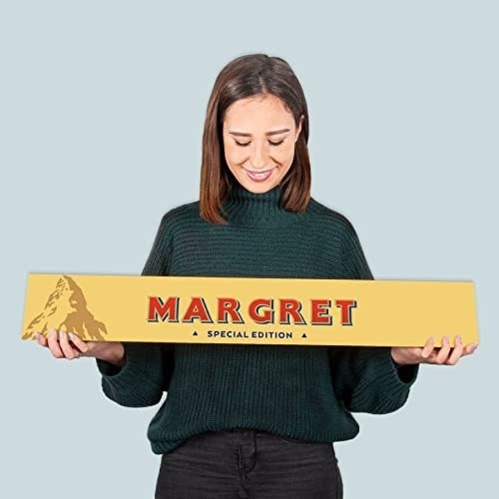 model holding 4.5 kg chocolate bar customized to say "Margret"
