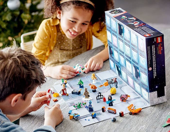 two children playing with the figures from the advent calendar