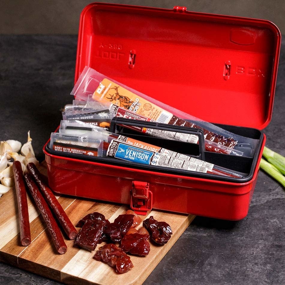 a red tool box filled with jerky bites and sticks