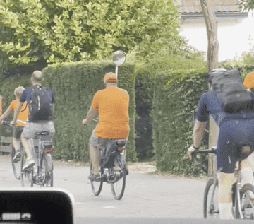 GIF of loads of people cycling through amsterdam streets