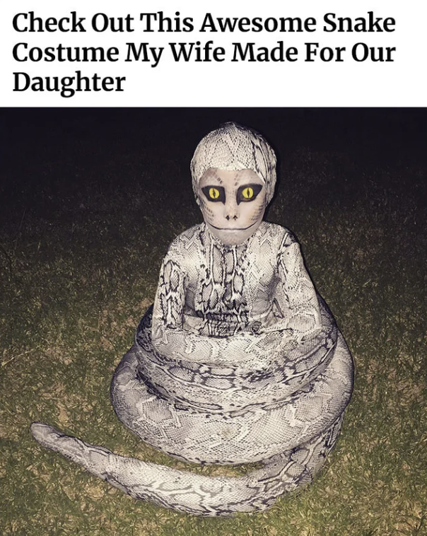 A child dressed as a snake
