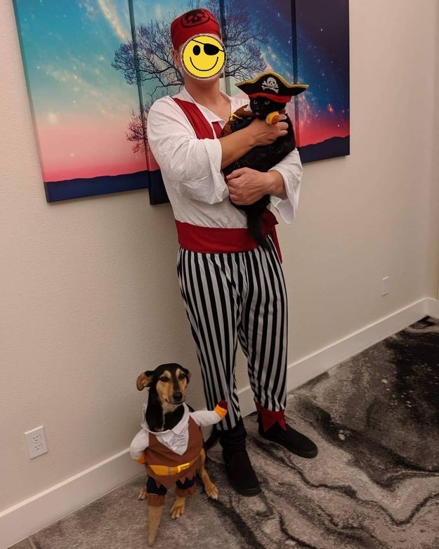 image of a guy with his two pets wearing their costume for halloween