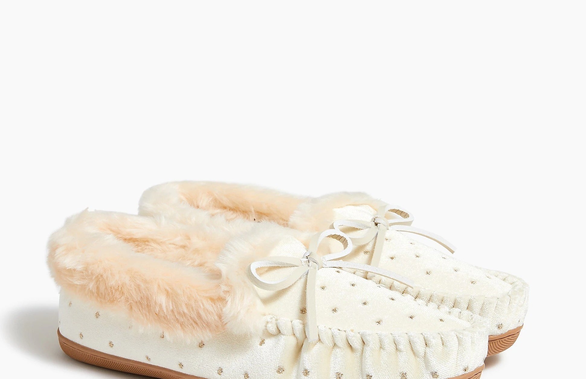 white faux shearling slippers with fur on the inside and bow on the front