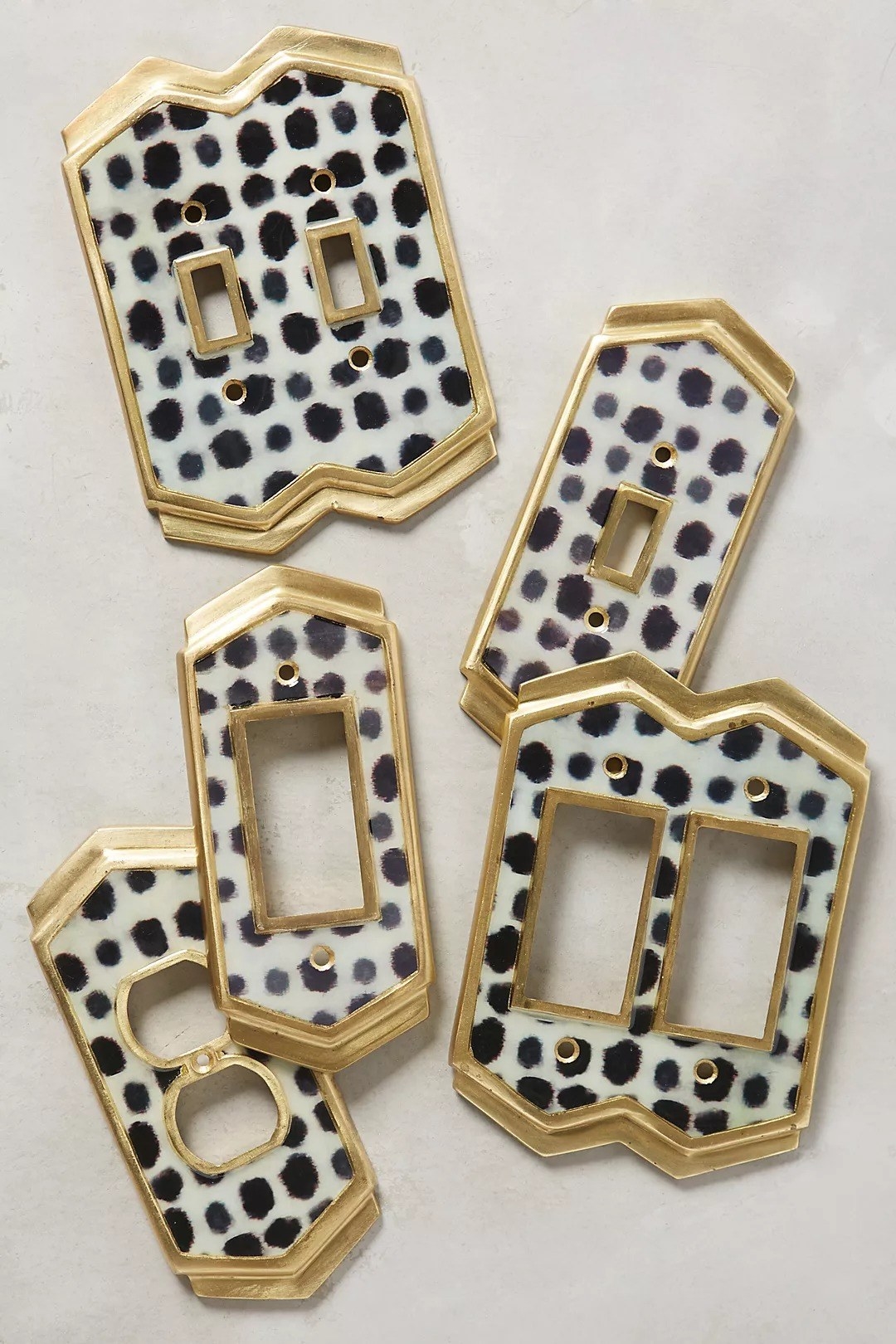 five different black and white dotted switch plate covers
