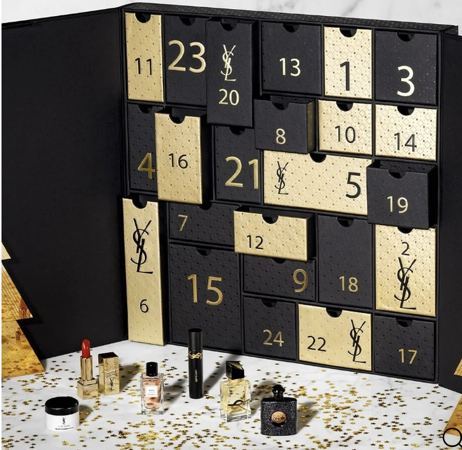 the advent calendar open with the boxes in place and a few of the minis in front of it