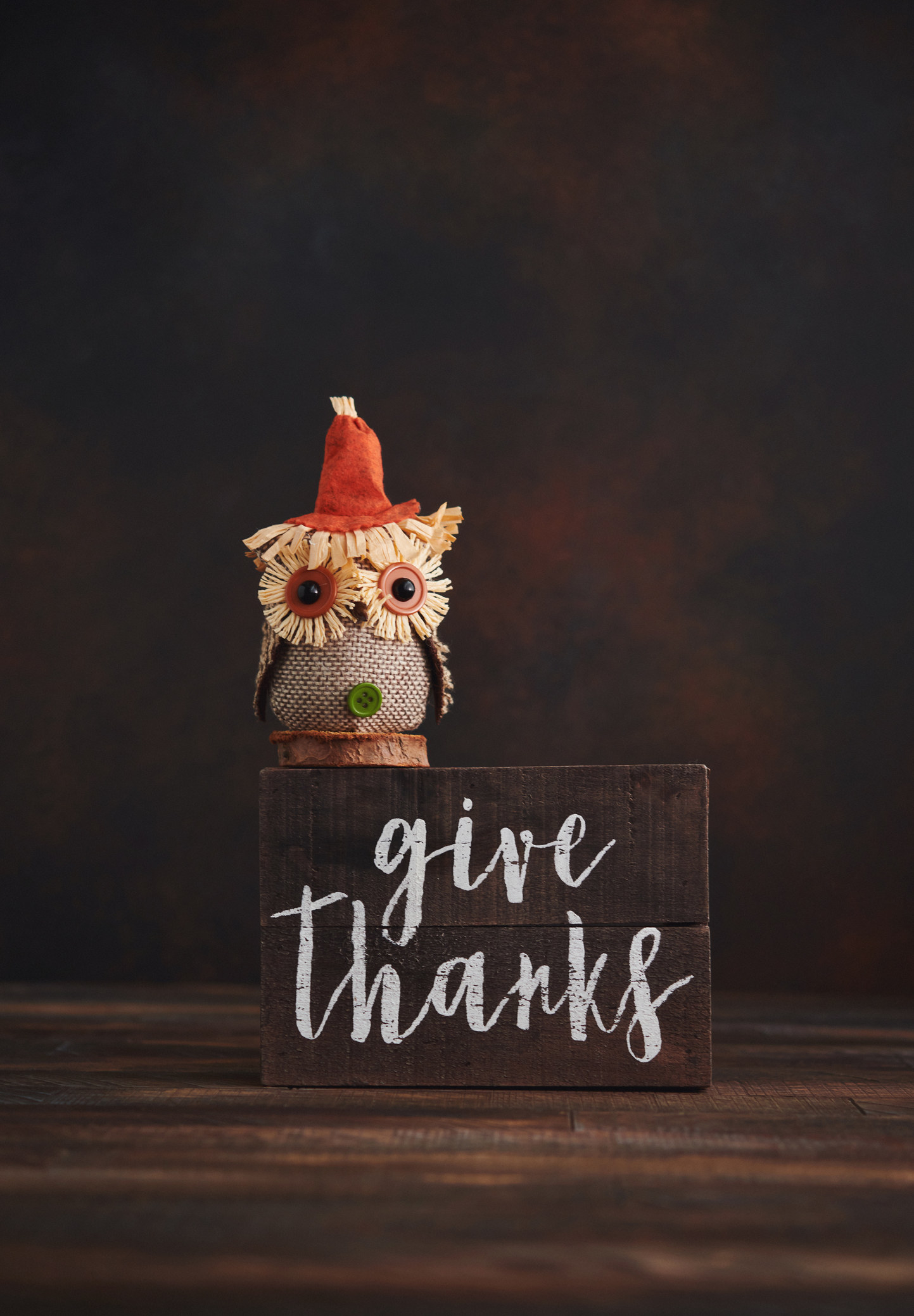 a give thanks decoration with a little owl doll on top