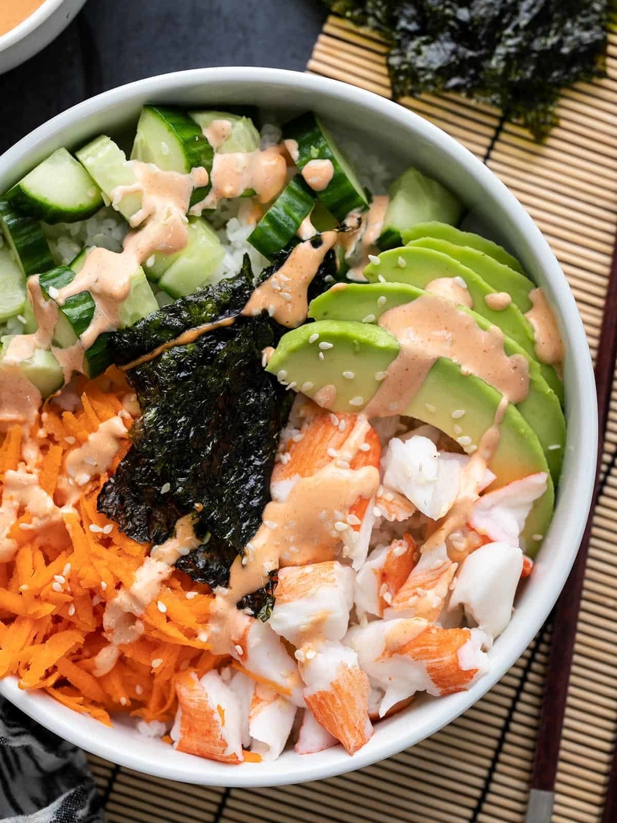 bowl with avocado, seaweed, carrots and crab